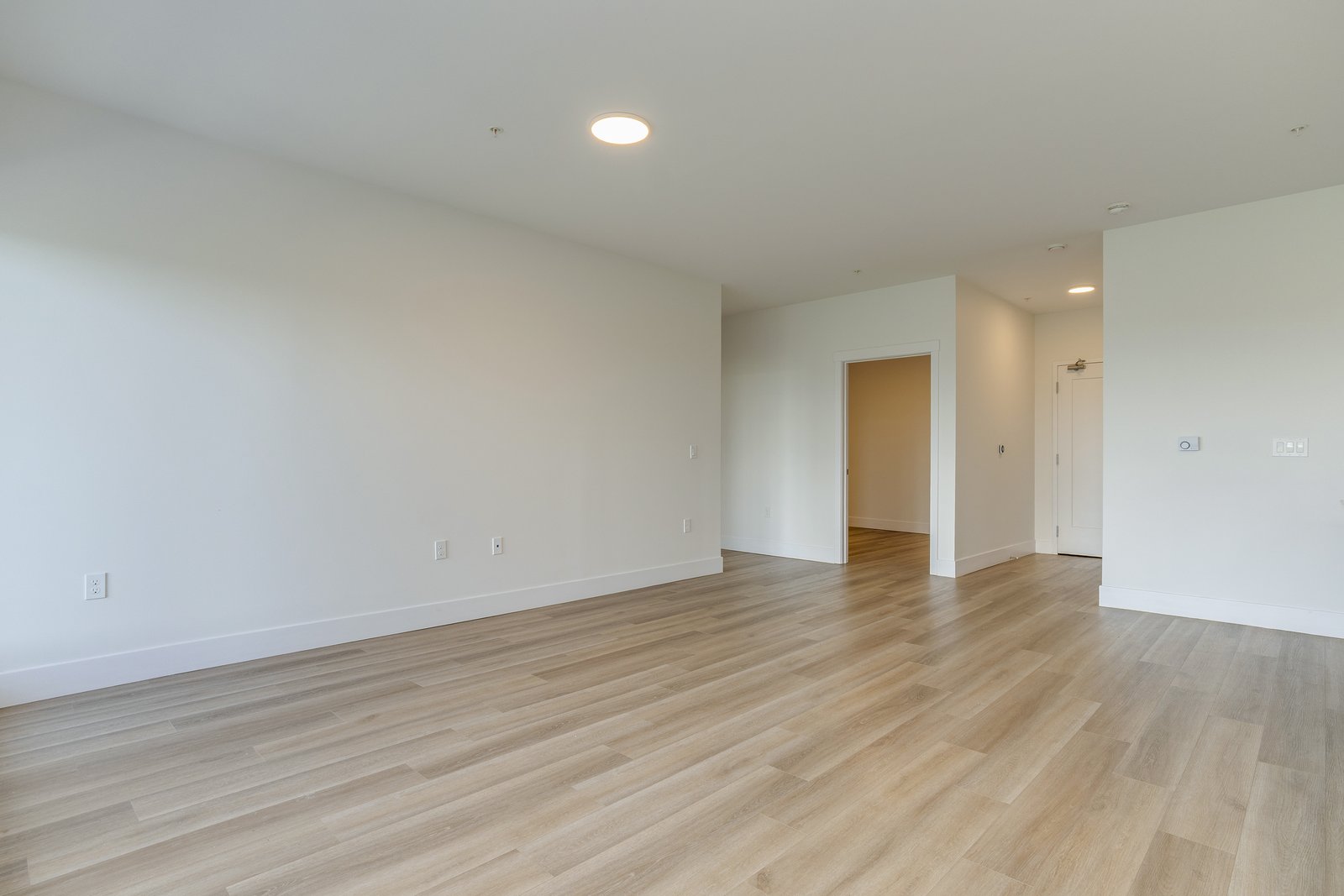 Open living room leading to the bedroom hallway